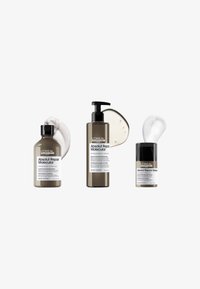 Kolme L'Oréal Absolut Repair Molecular hiustenhoitopulloa, joissa vaahto-, seerumi- ja kermaiset koostumukset valkoisella taustalla.