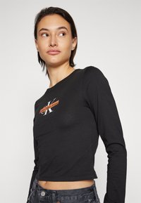 Calvin Klein Jeans SEASONAL MONOLOGO LONG SLEEVE - Camiseta de manga larga - black
