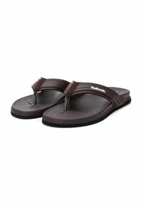 Chanclas marrones de goma, con suela texturizada, diseño de tira entre los dedos y correa de marca. Diseño minimalista con acabado suave.