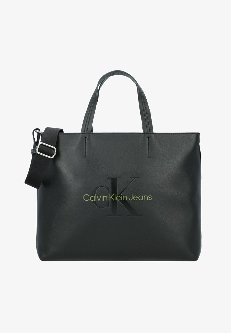 Schwarze synthetische Tragetasche mit doppelten Griffen und verstellbarem Schulterriemen. Mit geprägtem "CK"-Logo und "Calvin Klein Jeans" in Grün.