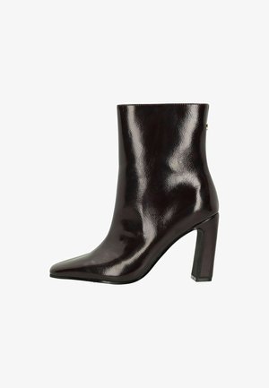 Burgundy patent leather ankle boot with a pointed toe and 4-inch block heel, featuring a smooth texture and minimalistic design.
