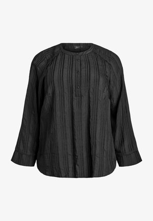 Musta pitkähihaista paitaa, jossa on pyöreä kaula-aukko, nappikiinnitys ja pystysuorat tekstuuriraidat. Rentoa istuvuutta ja napitettuja hihoja.