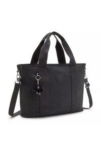 Black fabric tote bag with dual top handles and a detachable shoulder strap. Features a rubber logo and a black pom-pom charm.