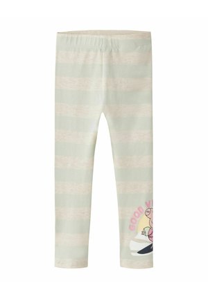 Leggings pour enfants avec des rayures horizontales beige et vert clair et un petit personnage de dessin animé avec le texte « Good Vibes » sur le bas de la jambe.