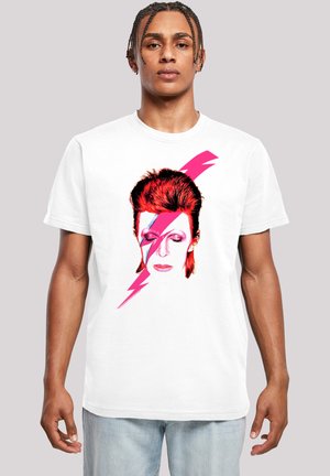 White cotton T-shirt featuring a graphic of a stylized face with red hair and pink lightning bolt accents, set against a plain background.