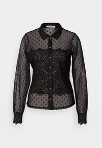 Blouse noire transparente avec des pois et des détails en dentelle, design avec col, manches longues, fermeture à boutons et poignets bordés de dentelle.