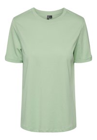 T-shirt di cotone verde chiaro con maniche corte arrotolate, scollatura rotonda e vestibilità rilassata. Texture liscia senza pattern o decorazioni visibili.