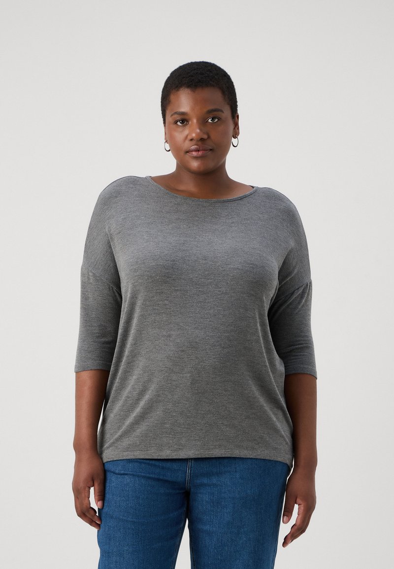 Gray, long-sleeve shirt with a wide neckline and relaxed fit, made of soft fabric, paired with blue denim jeans. Simple design without patterns.