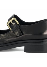 Black leather shoe with a buckled strap, flat heel, and smooth texture. Features a structured design with minimal accents.