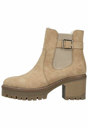 Beige ankle boot with a sturdy block heel, textured beige side panel, and metal buckle accent. Features a smooth suede finish and rugged sole.
