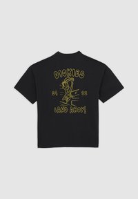 Black short-sleeve T-shirt with yellow cartoon graphic of a waving sailor, text "DICKIES," "29," "22," and "LAND AHOY!" on back.