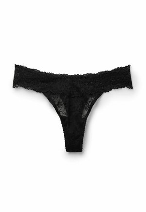 Tanga de encaje negro con patrón floral, con cinturilla de encaje con borde festoneado y cobertura mínima. Textura suave con material elástico.