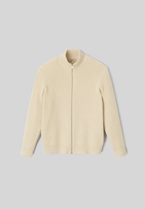Pull en tricot côtelé couleur crème avec un col haut et une fermeture éclair sur le devant. Il a des manches ajustées et un ourlet droit.