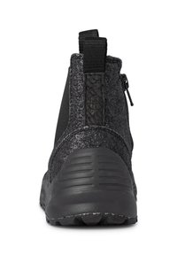 Black ankle boot with a textured, sparkling finish. Features elastic side panels, a back zipper, and a rugged, grooved sole.