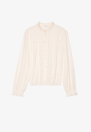 Blouse blanche à manches longues avec un col à volants, bouton devant et poignets élastiques. Présente un tissu texturé et une taille froncée.