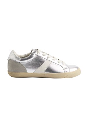 Metaliczne srebrne sneakersy o gładkiej powierzchni, z białymi skórzanymi akcentami, sznurowadłami i beżową gumową podeszwą. Okrągły czubek i niskoprofilowy design.