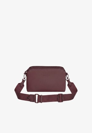 Small rectangular dark brown leather crossbody bag with adjustable strap and two zipper compartments, brand name subtly embossed on front.