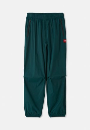 Pantalones de exterior en verde azulado oscuro, con una cintura elástica, dos bolsillos laterales con cremallera y puños elásticos en los tobillos. Material ligero.