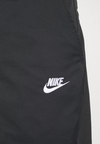 Nike Sportswear M NK CLUB TAPER LEG - Pantalones deportivos - black