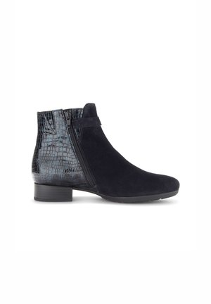 Black suede ankle boots featuring a glossy croc-embossed panel, side zipper, and a low block heel, combining texture and modern design.