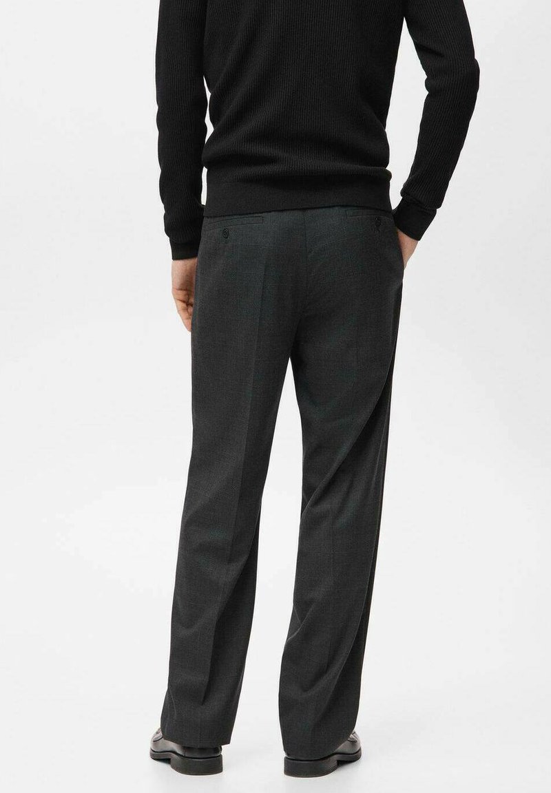 Dark gray tailored trousers with a straight fit, featuring two back pockets and a subtle check pattern. Worn with a black ribbed sweater.