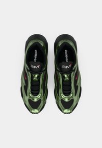 Green and black sneakers featuring a glossy finish, mesh panels, and a textured sole. Includes branding on the tongue and side.