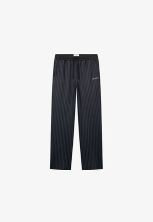 Dark navy lounge pants with vertical pinstripes, elastic waistband, drawstring, and "LES DEUX" logo, featuring a relaxed, wide-leg fit.