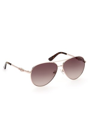 Ochelari de soare aviator cu un cadru metalic argintiu, cu lentile maro în degradeu și brațe din faviu de țestoasă. Prezintă pernuțe de nas clare și elemente decorative.