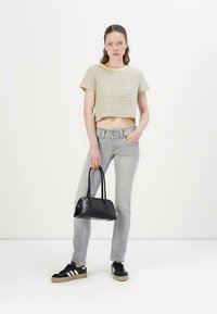 Rövidített, sárga csíkos top; világosszürke farmer; fekete kézitáska; fekete tornacipő fehér csíkokkal; egyszerű stílus és hétköznapi megjelenés.