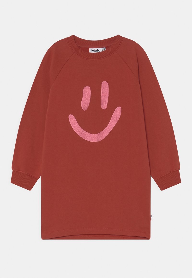 Robe chemise à manches longues de couleur rouille avec des poignets côtelés et un grand motif de smiley rose sur le devant.