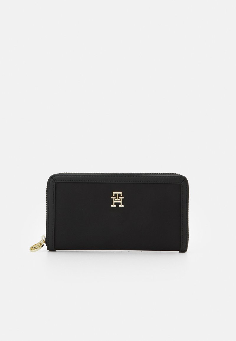 Black zippered wallet made of smooth material, featuring a gold logo on the front. Rectangular shape with stitched edges and zipper pull.
