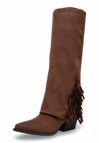 Botte western en faux suède marron avec un bout pointu, hauteur mi-mollet et détails de franges sur le côté. Caractérisée par un talon empilé.