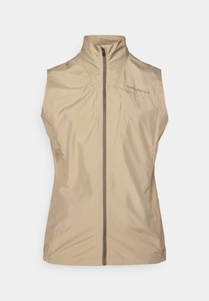 Beige sleeveless vest with a high collar, front zipper, and logo detailing. Made from lightweight, smooth fabric with a minimalistic design.