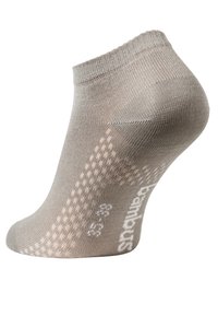 Calzino beige alla caviglia realizzato in materiale elastico, con un motivo di grip testurizzato sul lato e logo stampato in bianco vicino al tallone.