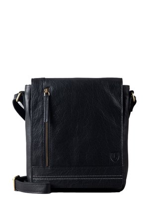 Black leather crossbody bag with a textured surface, a front zip pocket, and a shoulder strap. Features contrasting stitching and logo detail.