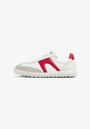 Sneakers featuring a white leather upper, red leather accents, and grey suede. Minimalist design with textured sole and lace-up closure.