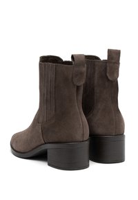 Brown suede ankle boots with block heels, pull tabs, and elastic side panels, shown from back and angled side view on white background.