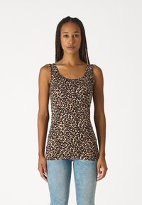 Leopard print tank top in soft fabric, featuring wide straps and a scoop neckline, paired with light blue jeans.
