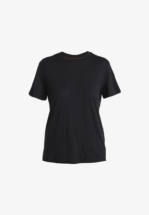 T-shirt noir à manches courtes en tissu doux. Présente un col rond classique et un ourlet droit avec des fentes latérales discrètes.