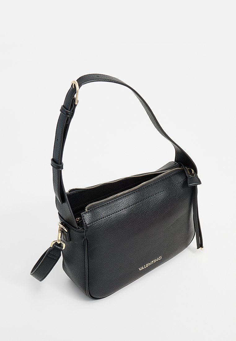 Sac bandoulière en cuir noir avec une bandoulière réglable, une fermeture éclair et des finitions en métal doré. Présente une surface texturée et un logo embossé.