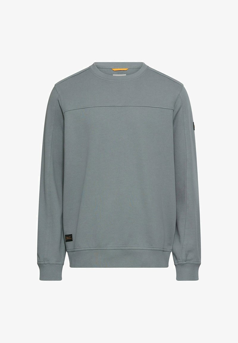 Jasnoszara bluza z okrągłym dekoltem, długimi rękawami i ściągaczami na mankietach. Posiada poziome szwy na wysokości klatki piersiowej oraz małą naszywkę z logo.