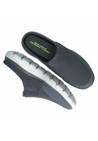 Black mesh slip-on shoes with memory foam insoles and a textured gray and white rubber outsole. Features a low profile and elastic side panels.