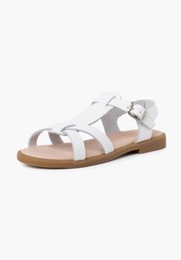 White sandals featuring multiple straps, a flat sole, and a gold buckle detail. Made of smooth material with a textured footbed.