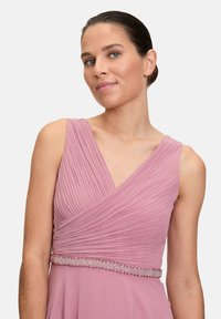 Roze geplooid jurkje met een diepe V-hals en een gedetailleerde, met kralen versierde tailleband. Het gladde, soepele materiaal creëert een elegante silhoutte.