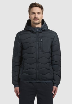 Padded navy jacket with wavy pattern, front zipper, hood, and chest pocket. Features elastic cuffs and a solid hem for insulation.