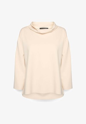 Top a maniche lunghe color crema con ampia scollatura a risvolto e orlo leggermente curvo, realizzato in tessuto liscio.