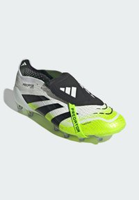 Soccer cleat with a gray, black, and neon green color scheme. Features a textured upper, slip-on design, and pronounced studs for traction.