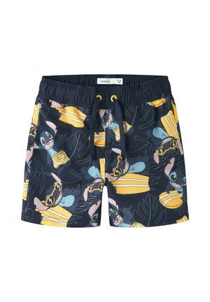 Shorts de bain pour enfants bleu marine avec taille élastique, motifs répétitifs de planches de surf jaunes et personnage de dessin animé portant des lunettes de soleil.