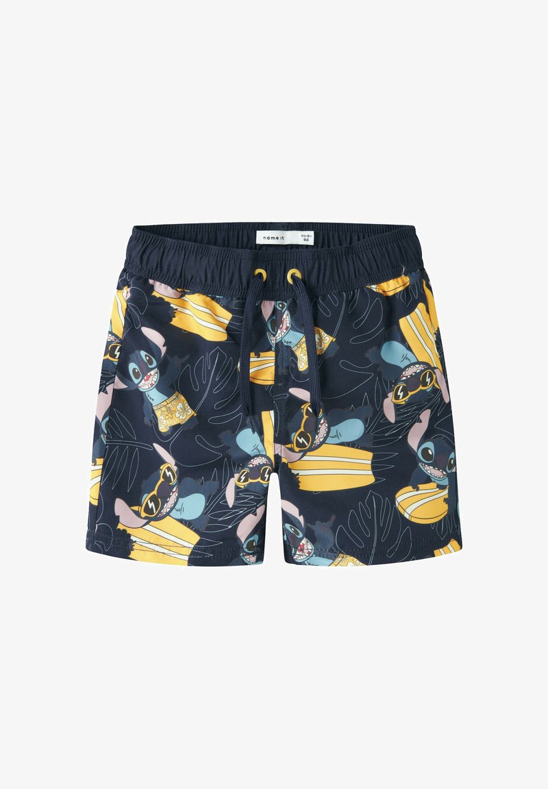 Shorts de bain pour enfants bleu marine avec taille élastique, motifs répétitifs de planches de surf jaunes et personnage de dessin animé portant des lunettes de soleil.