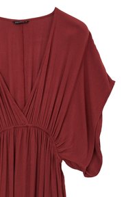 Rust-colored dress with a deep V-neck, short loose sleeves, and gathered fabric details at the waist. Soft, lightweight material with a textured finish.